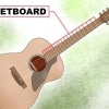 Spelar skalor på en gitarr