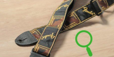 Hur man fäster ett gitarrband på din gitarr